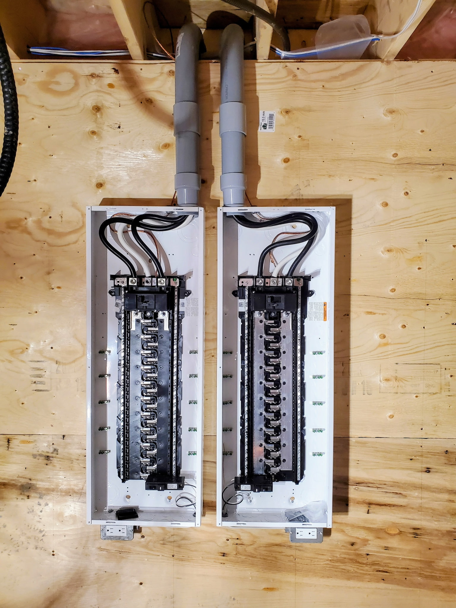 Two new breaker panels installed side by side with neatly run circuit wiring